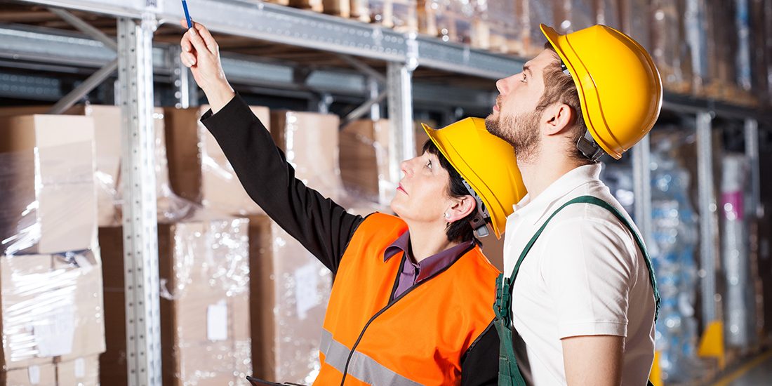 Warehouse engineer ordering to worker how to work